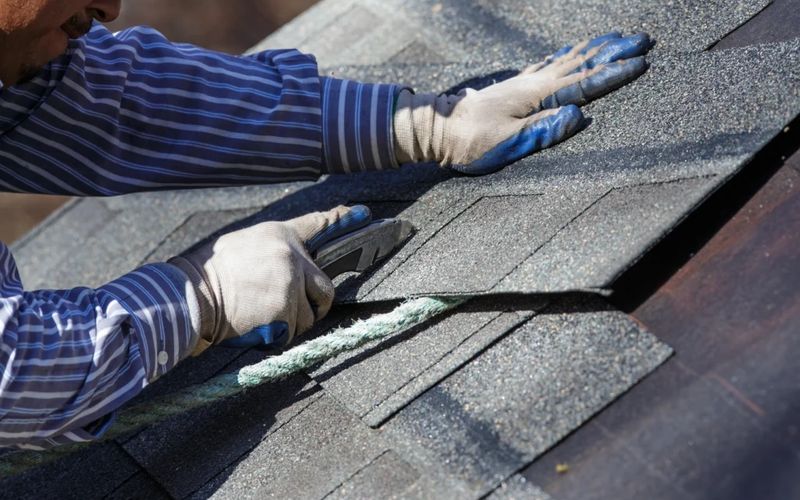 Contractor installing architectural shingles during a roofing upgrade